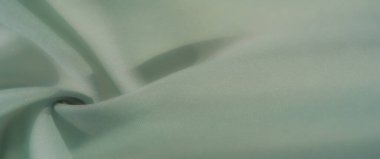 Nane yeşili bir tekstil. Zarif kıvrımları ve hassas bir dokusu var. Doğal ışık ve gölgelerin etkileşimi ince güzelliğini ve zamansız basitliğini arttırır..