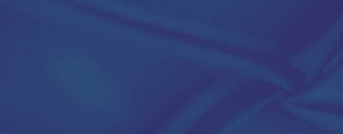 Görüntü. Yumuşak kıvrımları ve pürüzsüz katmanlarıyla büyüleyici mavi bir tekstil. Minimalist kıvrımlarında sükunet ve karmaşıklık hissi uyandırıyor..