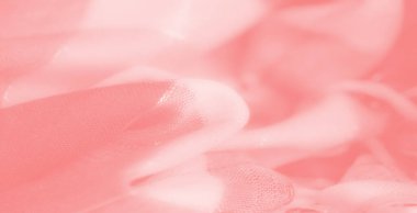 Işıldayan dokuları ve yıpranmış kenarları olan hassas mercan-pembe kumaş bulanıklığı, arka plan ve tasarımlar için mükemmel yumuşak ve dinamik bir soyut kompozisyon oluşturur..
