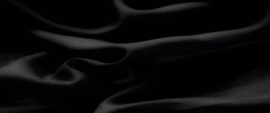 Görüntü zengin, yumuşak odaklı siyah kumaş kıvrımları, pürüzsüz dokularla rafine edilmiş zarafet, lüks moda, dekor ve sanatsal projeler için ideal..