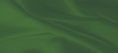 Pürüzsüz yeşil kumaş kıvrımları dalgalı ve dokulu bir görünüm yaratıyor. Kumaşın dokusunun karmaşık detayları zarif akışını ve derinliğini vurguluyor.