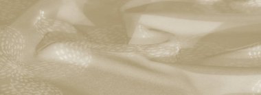Bulanık bej kumaş. Karmaşık çiçek desenleri var. Nazik kıvrımlar şeklinde örülmüş. İnce renkler ve doku şık ve sakin bir arkaplan için idealdir.