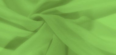 Zarif kıvrımları olan parlak yeşil kumaşlar lüks ve yumuşak bir doku yaratıyor. Akan çizgiler ve pürüzsüz yüzey çeşitli görsel tasarımlar için karmaşık bir arkaplan sunar.