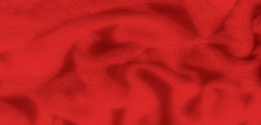 Yumuşak kıvrımlı, yumuşak kırmızı kumaşın bulanık görüntüsü lüks ve sıcak bir görünüm yaratıyor. Gölgeler yüzey boyunca oynarlar ve tekstil dokusuna zarif bir dokunuş eklerler.