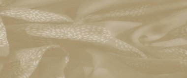 Bulanık bej tekstil, soyut, dalga benzeri deseni var. Yumuşak, zarif kıvrımlar sergiliyor. Yumuşak akış ve sessiz tonlar, dingin ve sofistike bir dokunuş ekler.