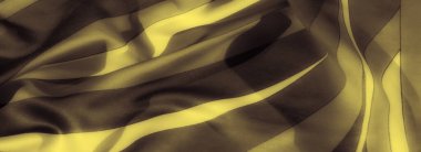 Karanlık bir zemin üzerindeki yumuşak altın dalgaların bulanıklığı katlanmış kumaş üzerinde zarif bir soyut desen oluşturur. Kibar kıvrımlar ve zengin tonlar lüks, dinamik bir görsel yaratıyor..