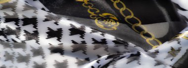 Altın zincir desenli siyah beyaz tekstil. Karmaşık bir dizaynla kalın zıtlıkları ve lüks dokuları harmanlıyor..