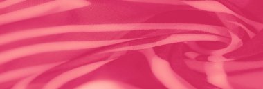 Görüntü, dalgalı kıvrımlar ve dinamik hareket ve ışık yayılımı hissi yaratan yumuşak çizgiler içeren pembe soyut bir kumaş. Sanatsal ve dekoratif kullanım için mükemmel.