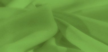 Yumuşak, organik katmanlarda katlanmış yeşil kumaş bulanıklığı pürüzsüz dokusundan zarafet yayıyor. Kibar kıvrımlar ve sakin renkler rahatlatıcı bir görsel etki sağlar..