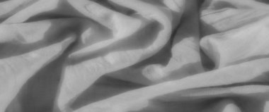 Gri tonlu bulanık kumaş ve karmaşık kıvrımlar çağdaş tasarımlar ve sanatsal görseller için pürüzsüz ve minimal bir doku yaratıyor..