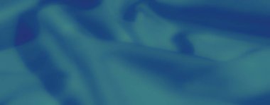 Süpürücü kıvrımları ve nazik kıvrımları olan mavi kumaş bulanıklığı. Yumuşak madde sükuneti yayar, sanatsal ve rahatlatıcı bir görsel deneyim yaratır..