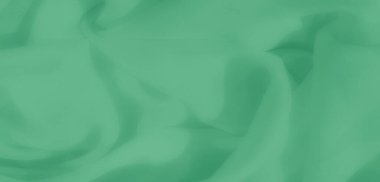 Yumuşak ve pürüzsüz renk ve doku akışına sahip çağdaş bir estetik sunan pürüzsüz yeşil kumaşın bulanıklığı..