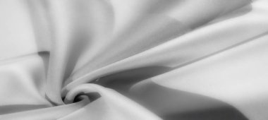 Görüntü - Zarif gri kumaş yumuşak, akışkan kıvrımlı yumuşak dokularla örtülmüş, dingin ve modern bir görünüm yaratıyor.