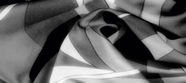 Görüntü. Katmanlı katmanlı ve aydınlıktan karanlığa gradyanlarla gri ölçekli minimalist kumaş zarafet ve derinlik saçan ince bir doku sergiliyor..