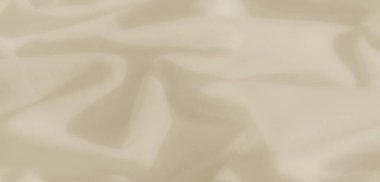 Yumuşak, organik kıvrımlı bulanık bej kumaş, açık gölgeli doğal bir doku yaratıyor. Malzemeler yumuşak dalgalar ve pürüzsüz yüzey bir sakinlik ve basitlik hissi uyandırıyor.