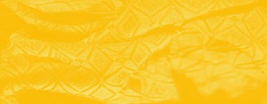 Detaylı yaprak kabartma ile parlak sarı tekstil, çeşitli uygulamalar için taze ve organik bir cazibe sağlar.