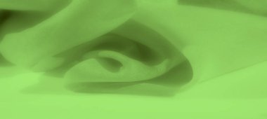 Yumuşak kıvrımlı canlı yeşil kumaşın bulanık etkisi. Kusursuz tasarım doğal olarak akar, arka plan ya da tekstil deseni için ideal ama pürüzsüz bir yüzey sunar..