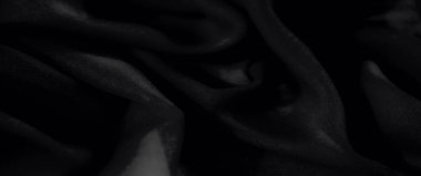 Görüntü, siyah kumaş akışkan bir hareketle çekildi, yumuşak kıvrımlar ve bir mat dokusu sergileniyor, moda veya iç tasarım projeleri için ideal..