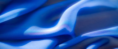 Parlak mavi kumaşın bulanık kıvrımları ve canlı bir son modern ve minimalist temalar için çarpıcı bir tasarım oluşturuyor..
