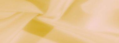 Bulanık - yumuşak, parlak sarı kumaş, ince kıvrımlı ve parlak bir kaplama. Canlı doku sanat ve tasarım için çağdaş ve sakin bir görsel yaratıyor.