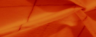 Yumuşak turuncu kumaştan bulanık ince kareli desenler, karmaşık kıvrımlar ve görsel olarak memnun edici soyut bir etki yaratan dokular..