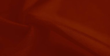 Görüntü: İnce dokuları ve akışkan kıvrımları olan canlı kırmızı bir kumaş tasarım projeleri veya tekstil fotoğrafçılığı için zarif ve çağdaş bir estetik sunar.