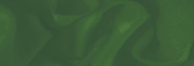 Yumuşak, doğal kıvrımları olan yeşil kumaş bulanıklığı ve akıcı bir doku, kusursuz geçişleri vurguluyor ve zarif, modern bir görünüm için dinamik hareketi vurguluyor.