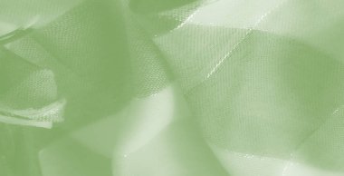 Görüntü - Yeşil kumaş, şeffaf bir görünüm ve ince bir ışık oyunuyla, sanatsal ve dekoratif çekiciliğini arttıran ruhani bir estetik yaratır..