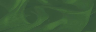 İnce dokuları ve yumuşak kıvrımları olan katmanlı yeşil kumaş bulanıklığı. Pürüzsüz yüzey tasarıma sakin ve minimalist bir cazibe ekler.