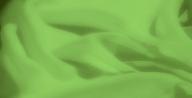 İnce kıvrımlı parlak yeşil kumaştan bir bulanıklık ve pürüzsüz bir kaplama taze, organik bir görünüm yaratıyor. Tekstil yumuşak dokusu, çevre dostu ya da doğa temalı tasarımlar için mükemmel bir sakinleştirici etki ekler.