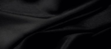 Karmaşık kıvrımları ve yumuşak gölgeleri olan koyu siyah kumaş bulanıklığı büyüleyici ve minimalist bir doku oluşturuyor. Sanatsal ve modern tasarımlar için ideal.