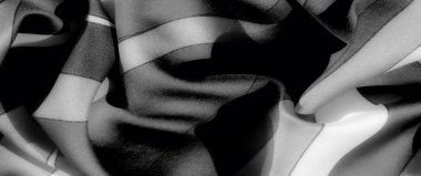 Görüntü. Katmanlı katmanlı ve aydınlıktan karanlığa gradyanlarla gri ölçekli minimalist kumaş zarafet ve derinlik saçan ince bir doku sergiliyor..