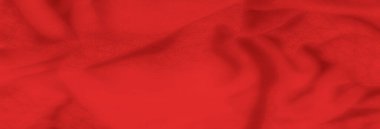 Sıcak, pürüzsüz bir dokusu ve yumuşak kıvrımları olan bulanık kırmızı kumaş zarif ve lüks bir his yaratıyor. Gölgeler bu tekstilin zenginliğini ve derinliğini arttırır..
