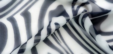 Bulanık siyah ve beyaz soyut kumaş. Yumuşak, kıvrımlı çizgiler var. Sıvı tasarımı ve pürüzsüz dokusu malzemeye modern ve şık bir estetik veriyor..