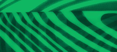 Siyah dalgalı aksanlı yeşil kumaş bulanıklığı. Görüntü, modern bir soyut tarzda derinlik ve dokuyu çağrıştıran katmanlı kıvrımlar ve gölge desenleri içeriyor..