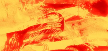 Parlak kırmızı ve sarı renkli bulanık kumaş. Parlak dokular ve karmaşık desenler. Işıl ışıl ve ateşli estetik..