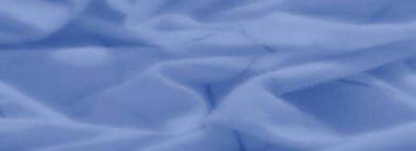 Üst üste binen kıvrımlar ve belli belirsiz aksanlar içeren yumuşak mavi kumaş bulanıklığı, tasarım veya yaratıcı altyapılar için ideal, dingin ve akıcı bir doku yaratıyor.
