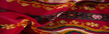 Bulanık - Karmaşık çiçek ve geometrik desenler bu kırmızı kumaş üzerinde parıltılı detaylar ve sıcak tonlarla birleşerek sanatsal, lüks bir doku oluşturur.