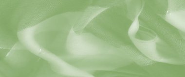 Bulanık, narin, şeffaf dokusu ve karmaşık iplikleri olan yumuşak yeşil kumaş. Akan malzeme soyut tasarımlar için mükemmel doğal bir zarafet sergiliyor..