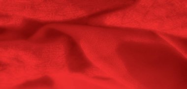Yumuşak kıvrımları ve yumuşak gölgeleri olan canlı kırmızı bir kumaşın bulanıklığı. Kumaş akışı ve zengin dokusu onu sıcak ve davetkar bir arka plan için ideal kılıyor.