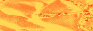 Görüntü bulanık sarı bir yüzey, dağınık kırmızı organik desenlerle süslenmiş, sanatsal ve enerjik bir görünüm veriyor..