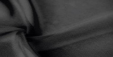 Yumuşak dokuları ve doğal kıvrımları olan bulanık siyah kumaş. Pürüzsüz bitiş ve az gösterilen zarafet modern tasarımlar için mükemmel, sofistike ve çok yönlü bir görünüm yaratır..