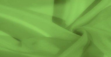 Parlak yeşil kumaş bulanıklığı yakın plan olarak katlanır, ince dokular ve yumuşak katmanlar gösterir, arka plan kullanımı için ideal. Akıcı tasarım ve pürüzsüz doku onu soyut veya tekstil temalı için uygun hale getirir