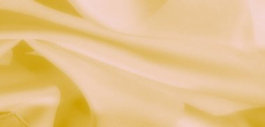 Akan kıvrımları ve yumuşak dokusu olan ince sarı bir kumaşı bulanıklaştır. Malzeme ışığı ve pastel tonlar zarif, sakin ve görsel olarak rahatlatıcı bir görünüm yaratır.