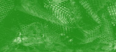 Bulanık yeşil örgü kumaş, dinamik desenler ve parıltılı bir efekt. Kalıplı katmanlar ve parlayan gölgeler sanatsal ve çağdaş bir cazibe yaratıyor..