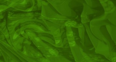 Sanatsal desenleri olan yeşil tekstil bulanıklığı ve güzel çiçek aksanları. Kumaş yumuşak kıvrımlara ve ince parlaklığa sahiptir, dekoratif veya moda kullanımı için mükemmeldir..