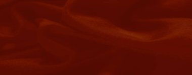 Bulanık kırmızı kumaş kıvrımları, arka plan tasarımları, sanat eserleri veya tekstil projeleri için mükemmel sofistike bir estetik yakalayan yumuşak ve lüks bir doku oluşturur..