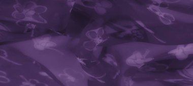 Çiçekli detaylarla süslenmiş saf mor kumaşın bulanık tabakaları yumuşaklık, zarafet ve ebedi güzelliğin görsel estetiğini yaratıyor..