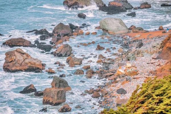 Beautiful landscape, raw power and beauty of the ocean, close-up. The rough texture of the rocks contrasts with the fluidity of the water and waves, evoking a sense of awe, and wonder.