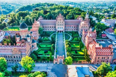 Aerial view of Yuriy Fedkovych National University, Seminar Residence and Church of the Three Hierarchs. Old historical university building with towers, domes, and green garden Chernivtsi, Ukraine